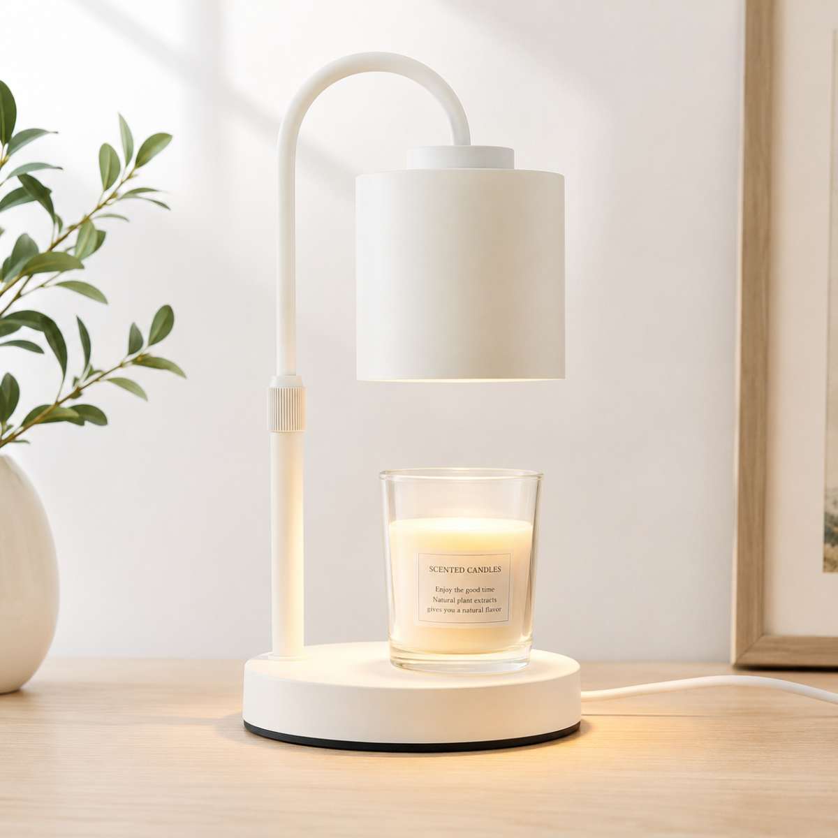 Minimal white candle warmer lamp styled on a bright clean bedside table