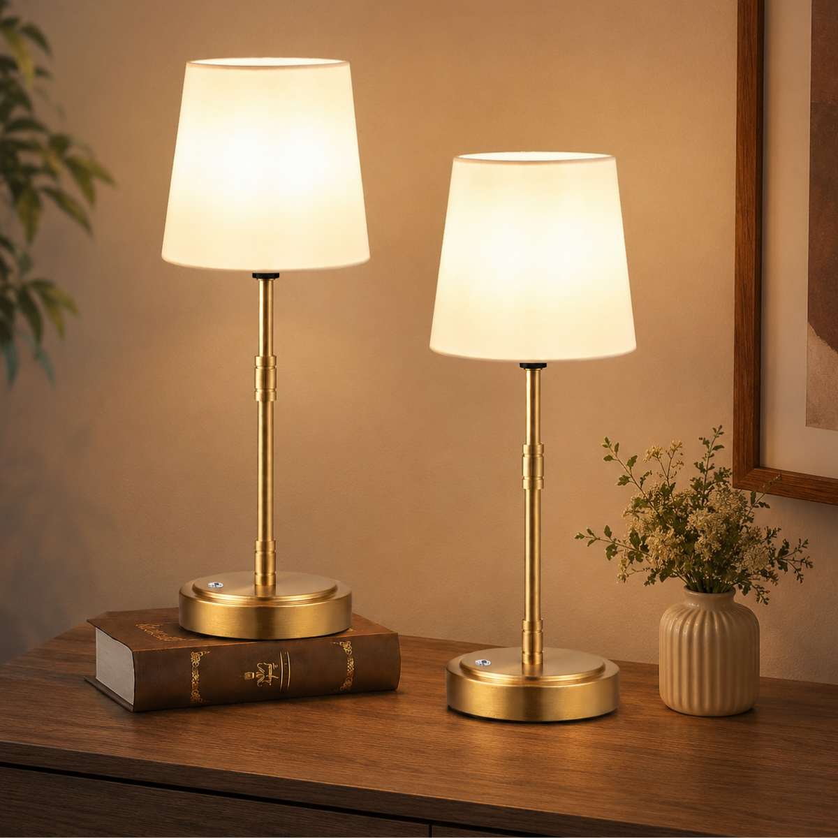 Vintage style cordless lamp with a warm glow styled on a nightstand with a book and glasses