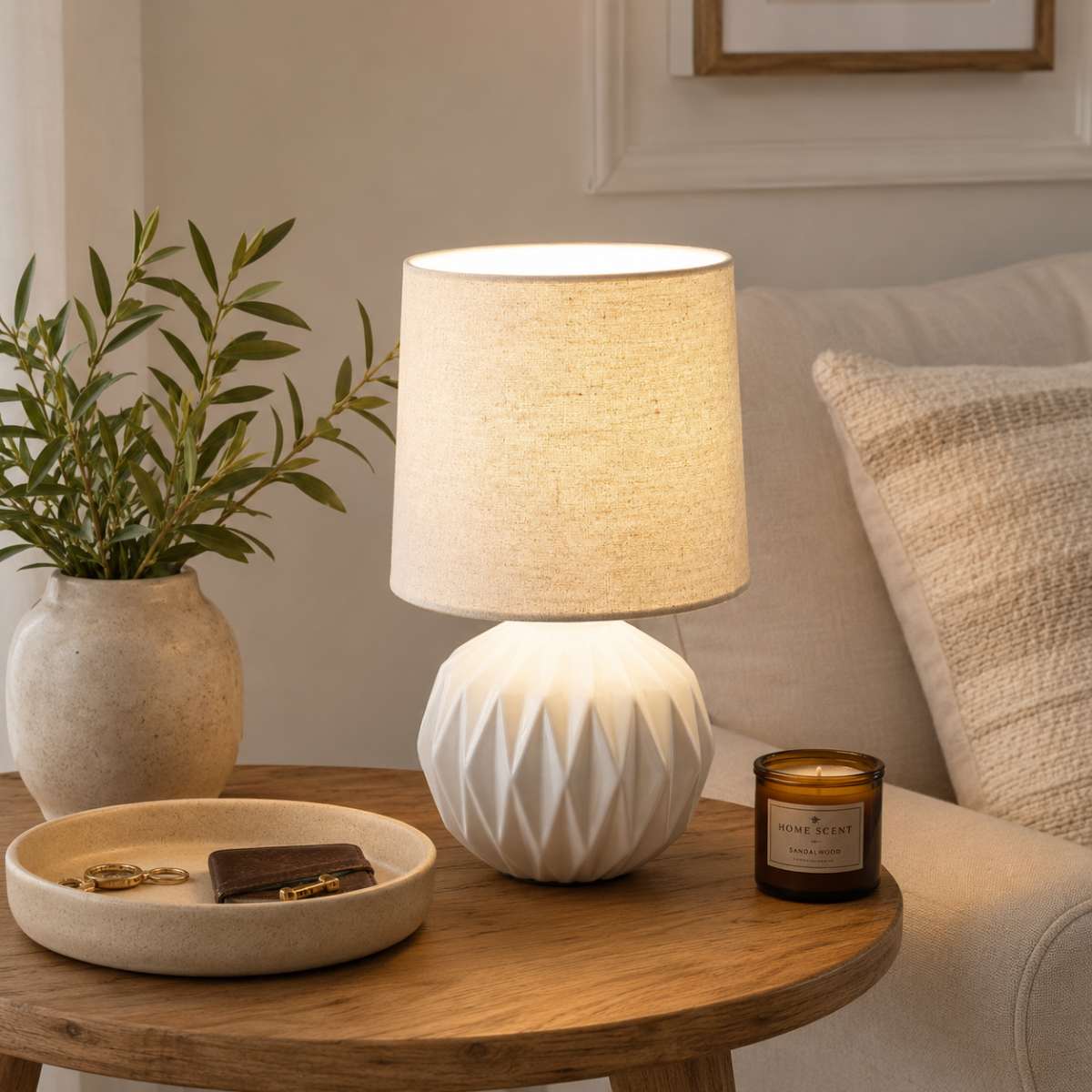 White geometric ceramic table lamp with soft neutral styling and stone accessories